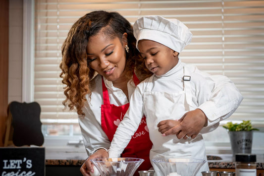 A picture of an African American chef and her son cooking in the kitchen 
