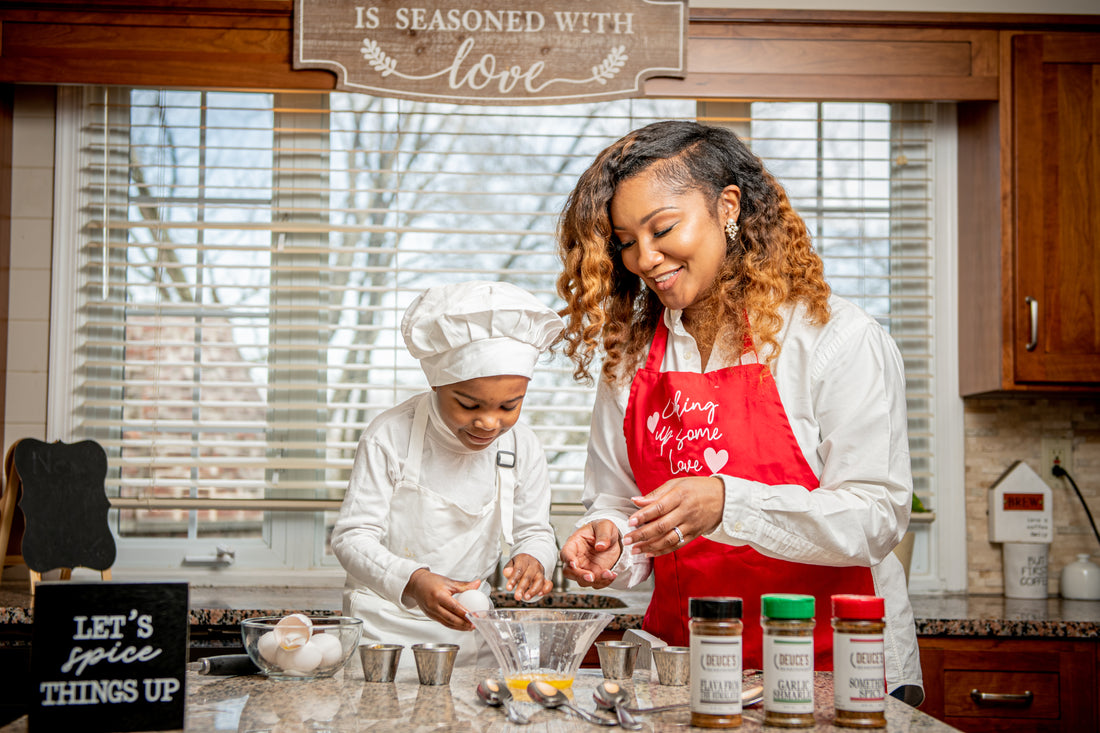 a wide angled photo of a mother and son cooking in a beautiful kitchen 